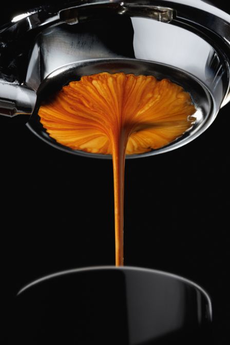 Home 20 Fresh espresso streaming into a cup, showcasing CoffeeFactz’s quality