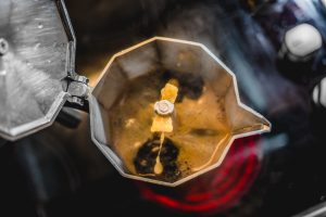 Top view of coffee brewing in a Moka Pot on a stovetop