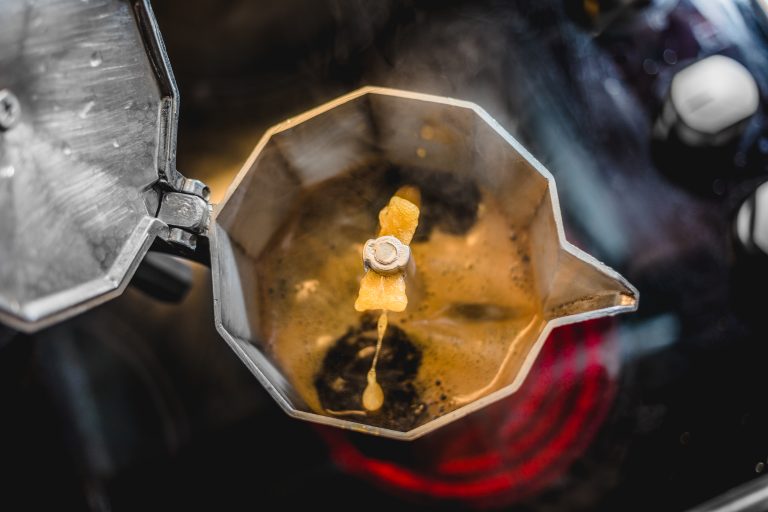 Top view of coffee brewing in a Moka Pot on a stovetop