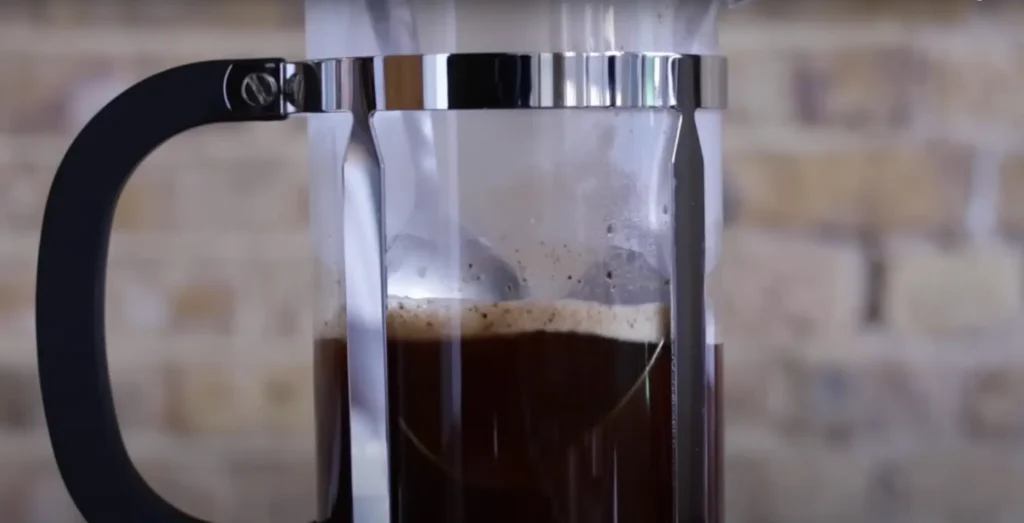 The Ultimate Guide to 12 Cup French Coffee Press Brewing 16 Two spoons are used to skim the foam off the surface of coffee in a French Press.
