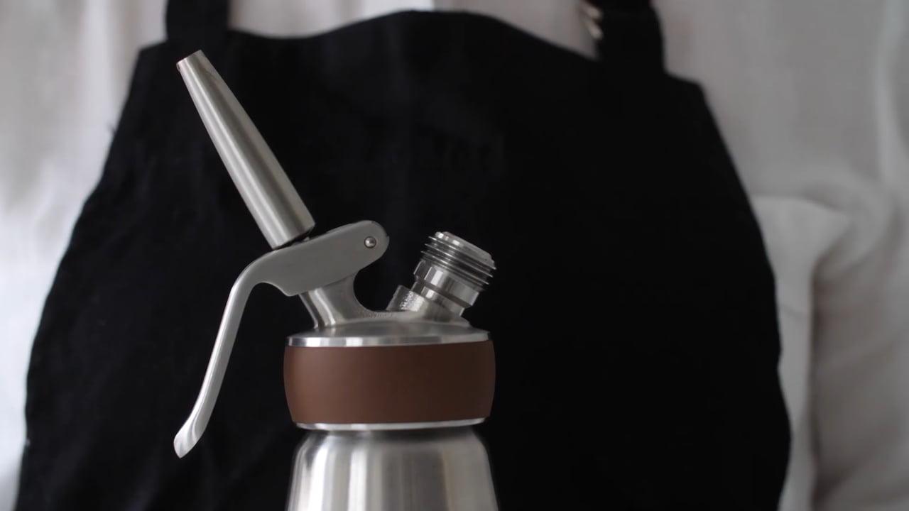 Nitro coffee dispenser head with nozzle attached to stainless steel bottle