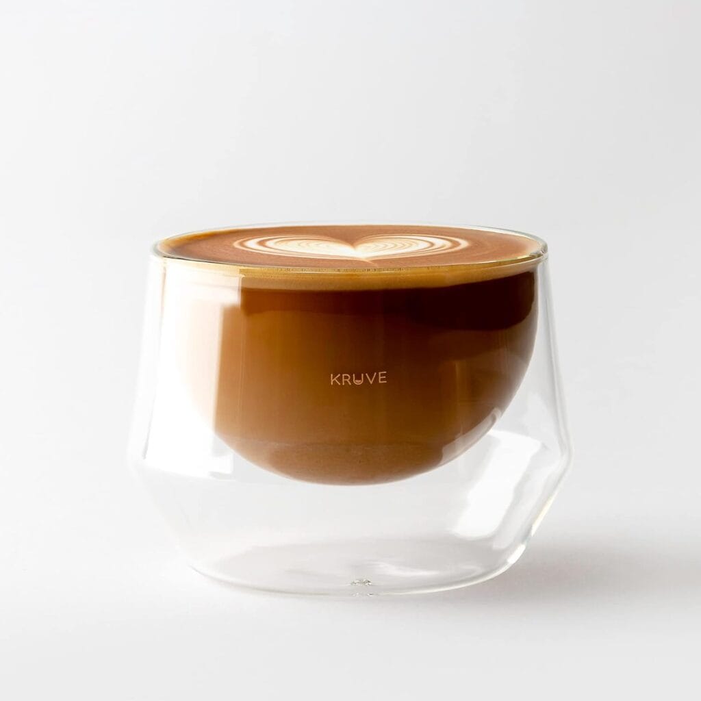 Finding Perfect Cortado Cup: A Journey Worth Taking 16 KRUVE Imagine 150ml double-walled glass with cortado coffee featuring heart latte art, showing unique angled base design and transparent layers