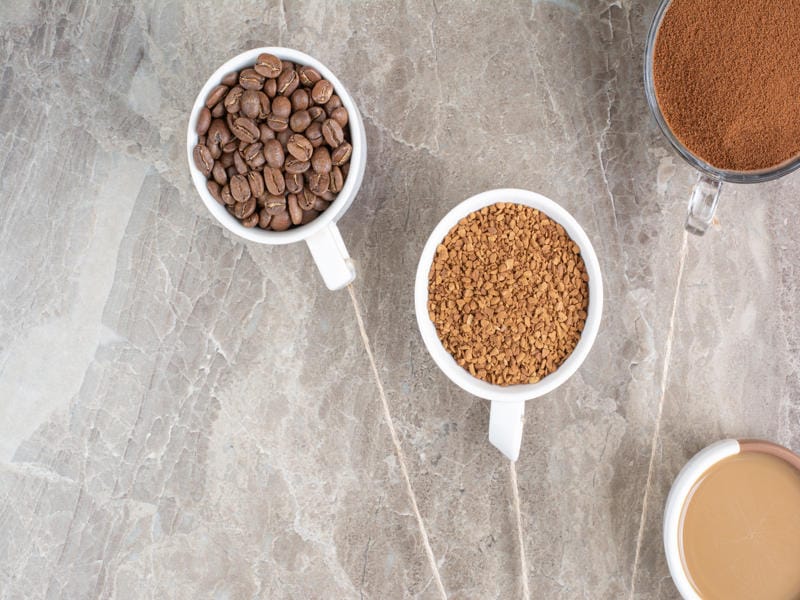 How Does Granulated Coffee Differ? 7 Coffee beans, granulated coffee, and brewed coffee in white cups showing flavor profile differences