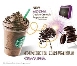 Starbucks Mocha Cookie Crumble Frappuccino topped with whipped cream and cookie crumbs beside coffee beans and chocolate cookies