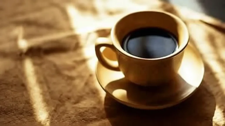 A cup of coffee next to a stethoscope representing coffee heart health benefits